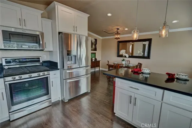 a kitchen with a refrigerator stove and microwave