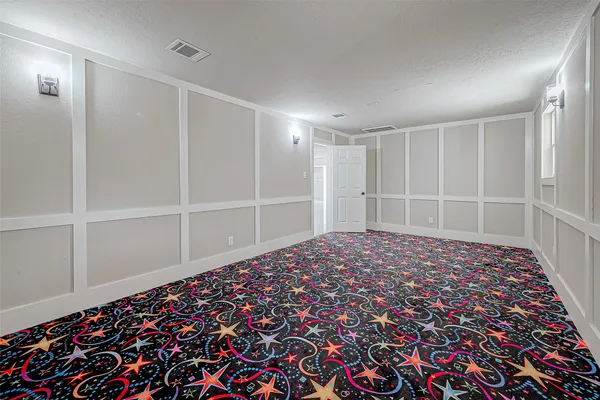 a big room with closet and wooden floor