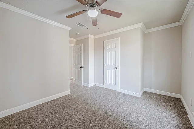 a spacious bedroom with a bed and a chandelier
