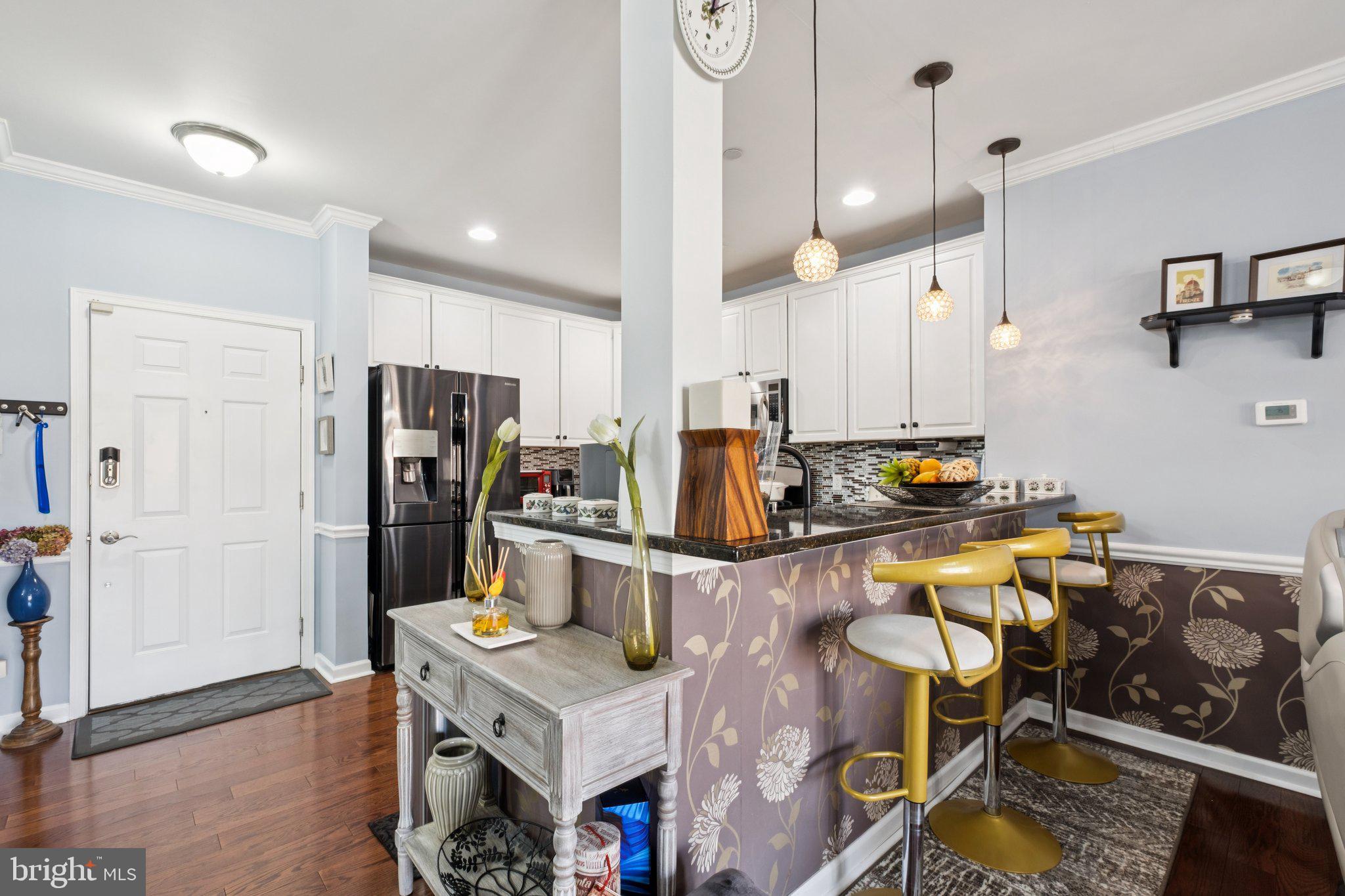 309 Carson Terrace Huntingdon Valley, PA 19006 - Photo 11 of 44 a kitchen with stainless steel appliances a refrigerator a stove a sink a dining table and chairs with wooden floor