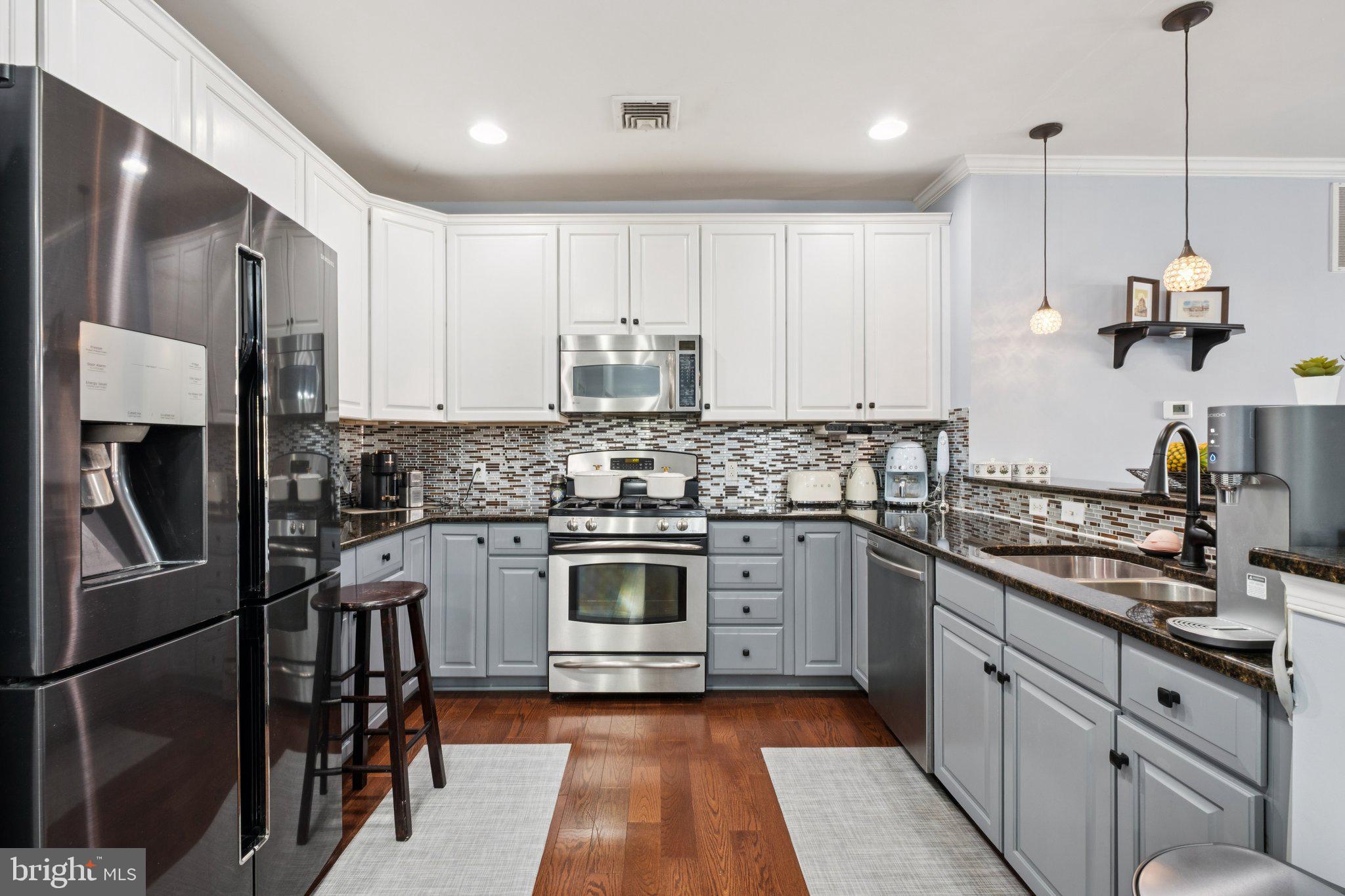 309 Carson Terrace Huntingdon Valley, PA 19006 - Photo 3 of 44 a kitchen with stainless steel appliances granite countertop a stove top oven a sink and cabinets