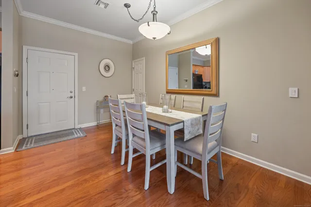 a view of a dining room with furniture wooden floor and chandelier