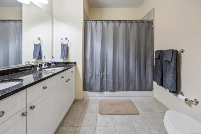 a bathroom with a double vanity sink and a mirror