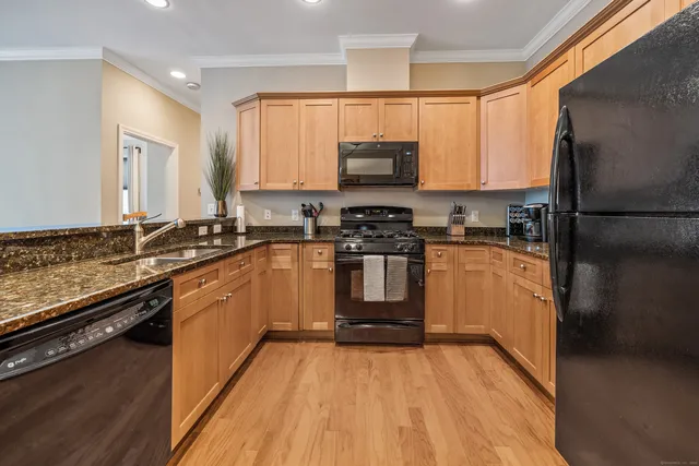a kitchen with stainless steel appliances a refrigerator sink stove microwave and cabinets