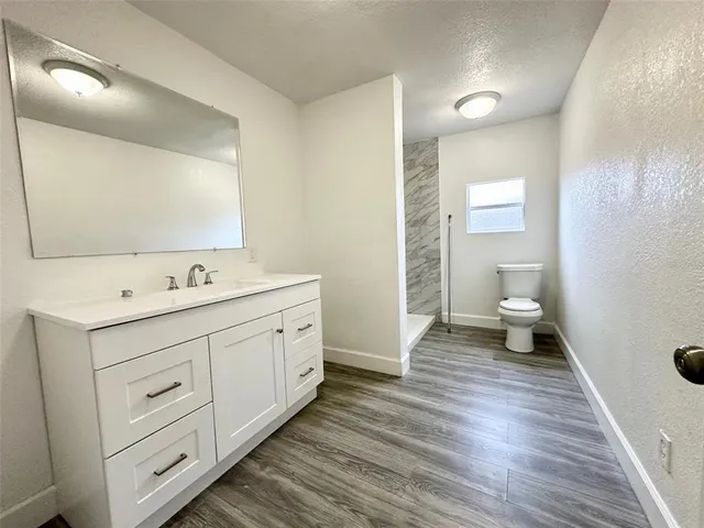 a spacious bathroom with a double vanity sink and a mirror