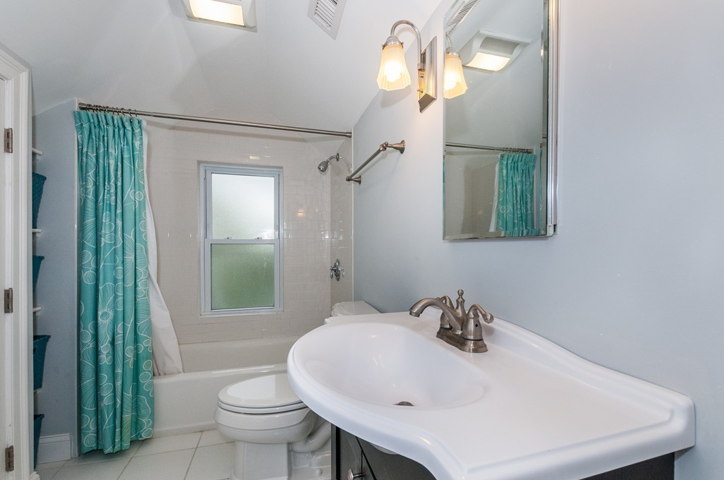 38 Lafayette Street, Unit 38 Arlington, MA 02474 - Photo 9 of 13 a bathroom with a sink a toilet and shower