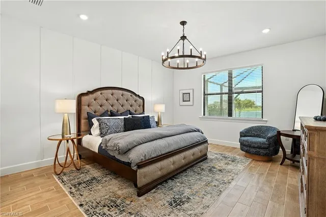 a bedroom with a bed and a chandelier