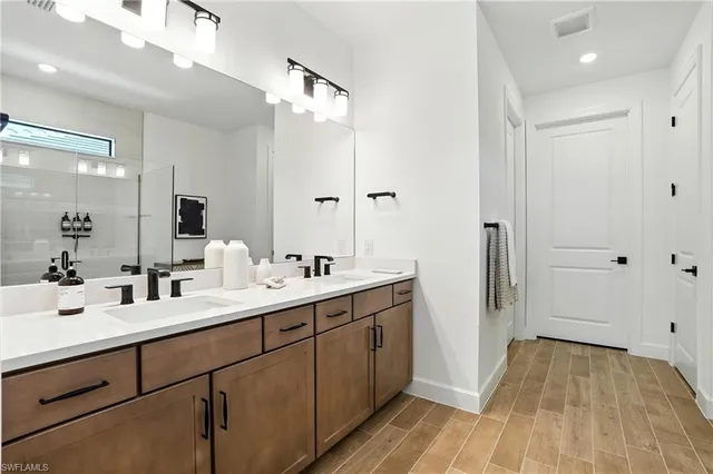 a bathroom with a double vanity sink and mirror