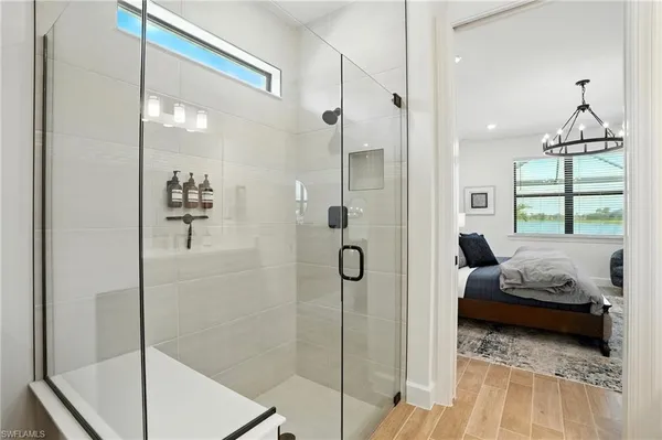 a bedroom with a bed and a chandelier