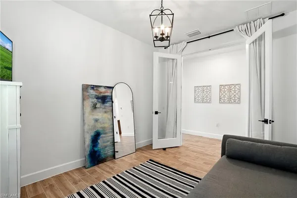 a bedroom with a bed and a chandelier