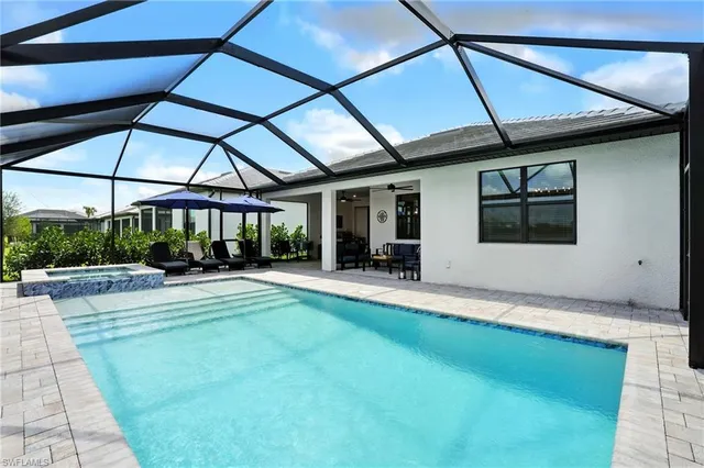 a view of a patio with a table and chairs under an umbrella