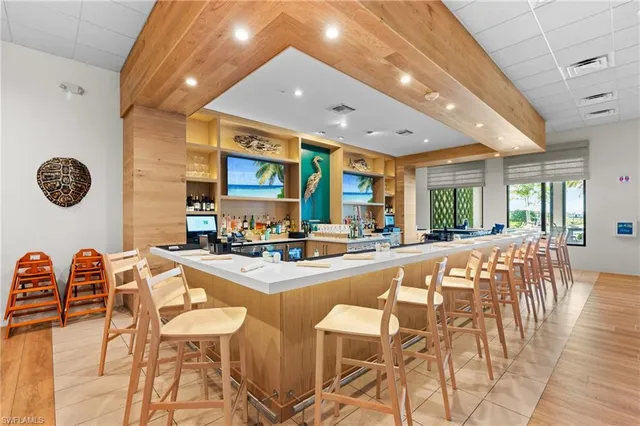 a large dining space with furniture and a large window