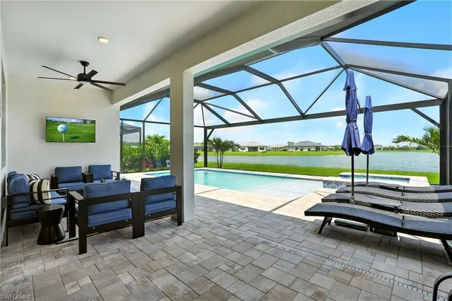 a living room with patio furniture and a floor to ceiling window