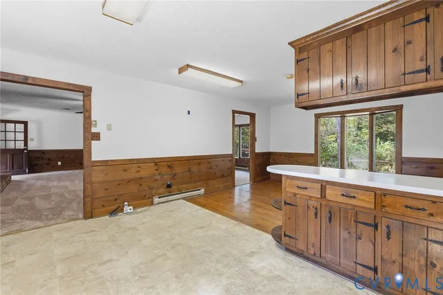 an empty room with a window and a ceiling fan