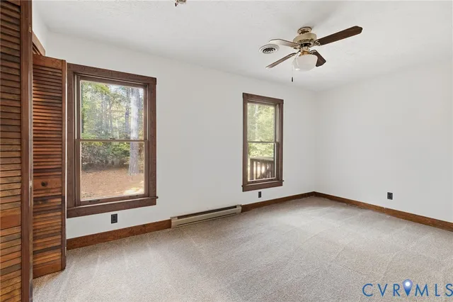 a bathroom with a granite countertop sink a toilet and a mirror