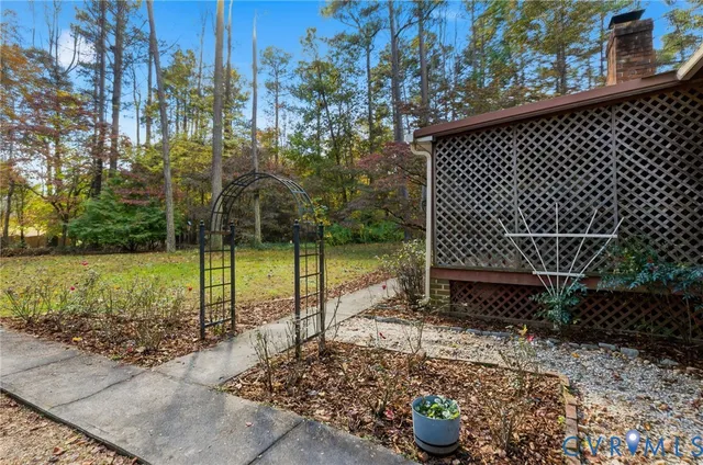a view of a house with a yard and tree