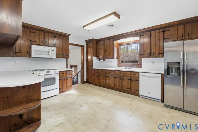 a kitchen with stainless steel appliances a stove top oven