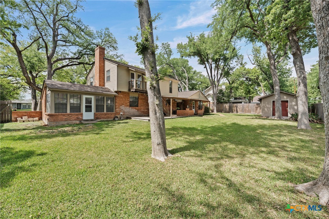1903 North Harding Avenue Cameron, TX 76520 - Photo 40 of 44 a view of a house with backyard and a tree
