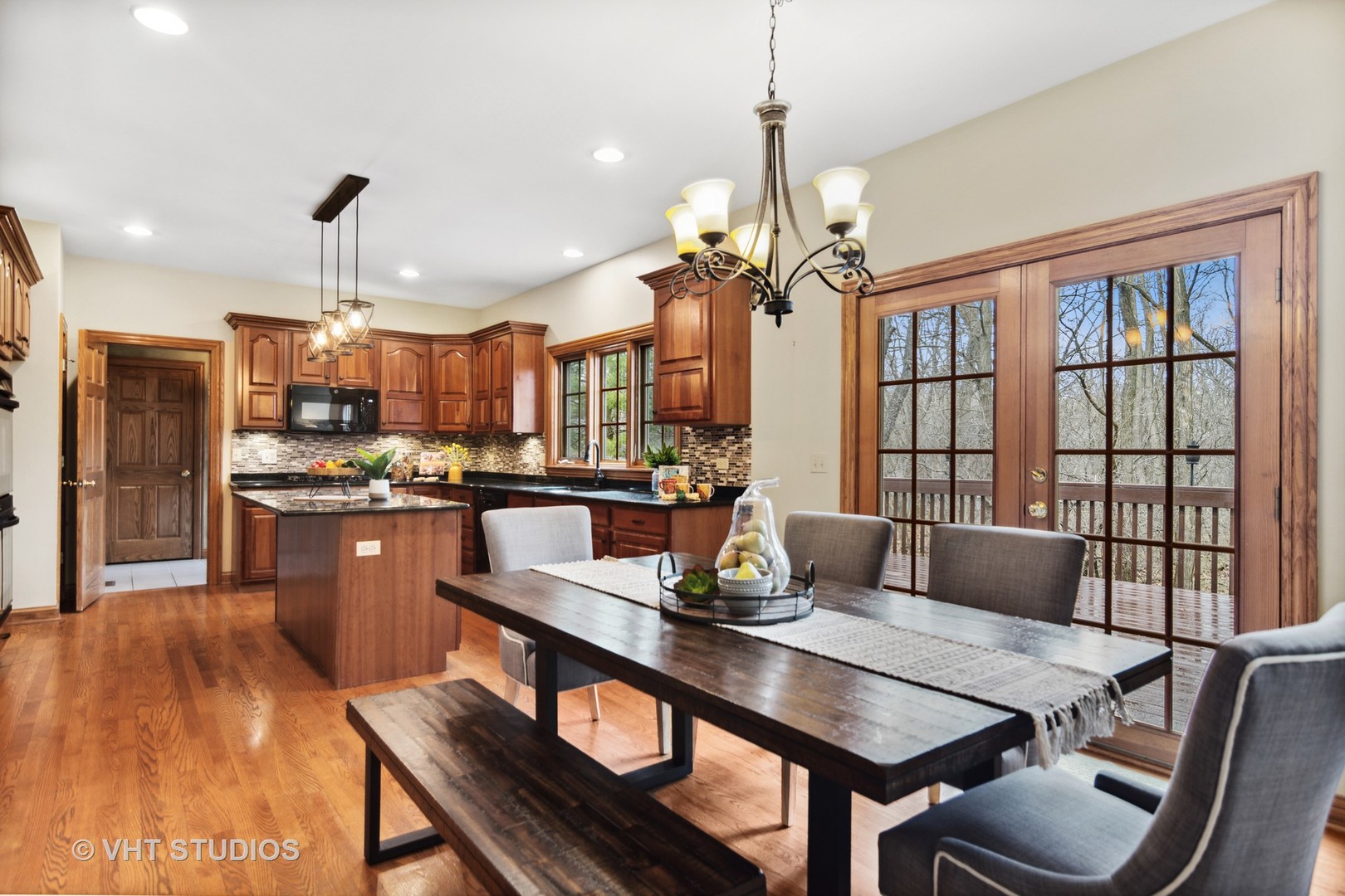 902 Bridle Lane Cary, IL 60013 - Photo 13 of 60 a kitchen with a dining table chairs stainless steel appliances and cabinets