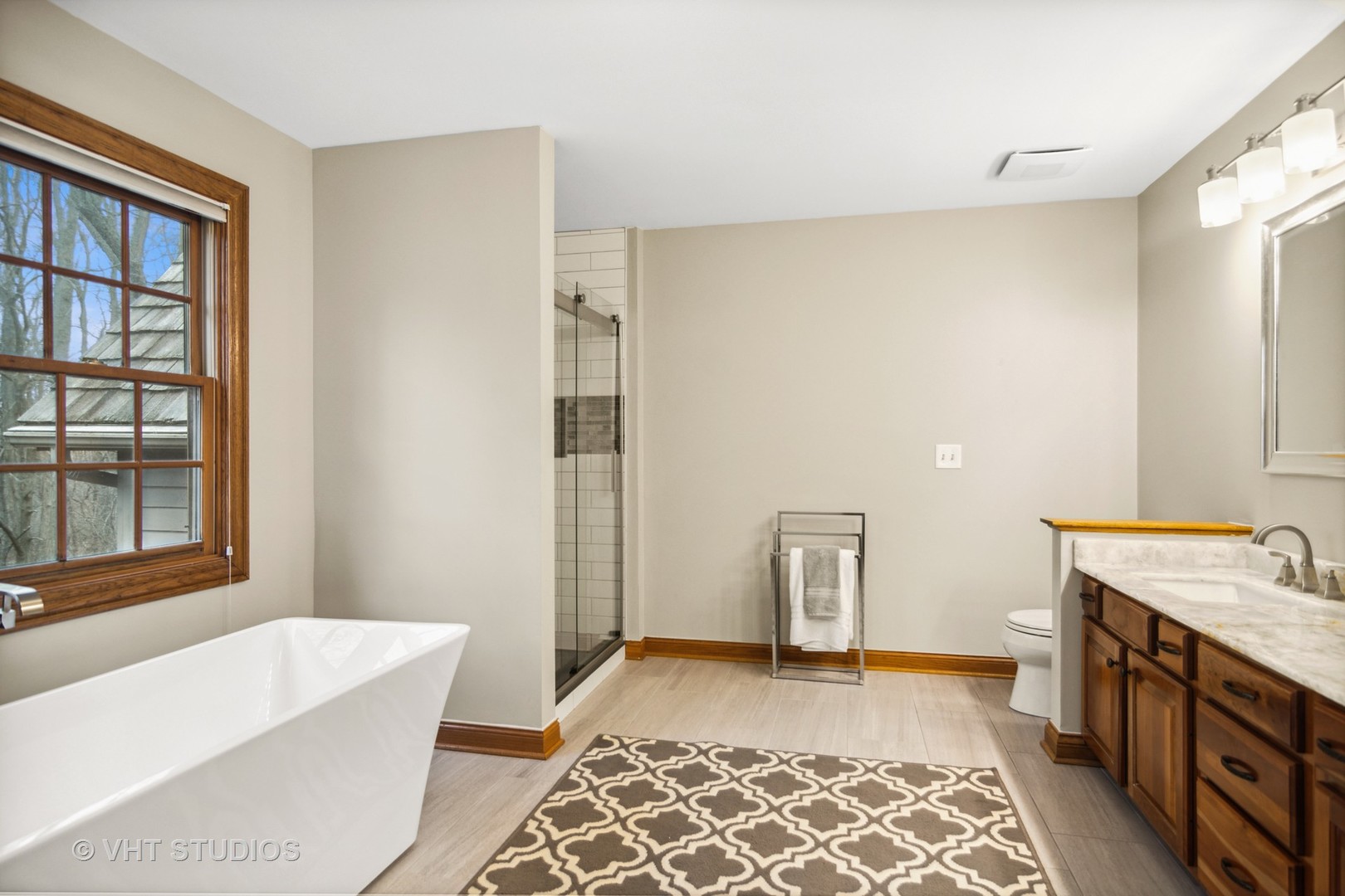 902 Bridle Lane Cary, IL 60013 - Photo 27 of 60 a bathroom with a tub sink and a mirror