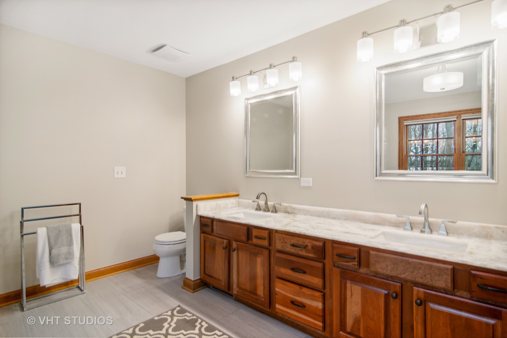 902 Bridle Lane Cary, IL 60013 - Photo 28 of 60 a spacious bathroom with a granite countertop toilet a double vanity sink a mirror and a window