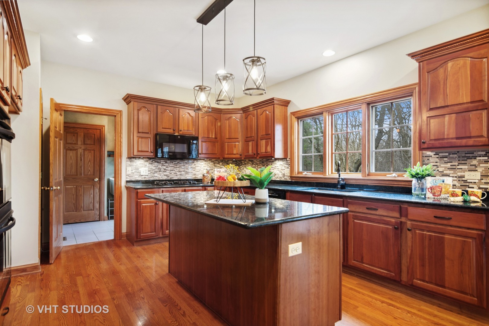 902 Bridle Lane Cary, IL 60013 - Photo 8 of 60 a kitchen with stainless steel appliances granite countertop a sink dishwasher a refrigerator and wooden cabinets