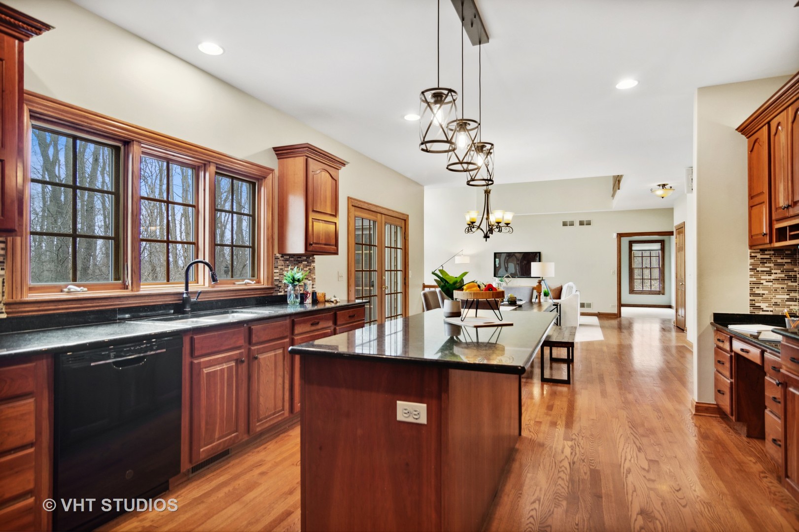 902 Bridle Lane Cary, IL 60013 - Photo 10 of 60 a very nice looking living room with kitchen island furniture a wooden floor and a sink