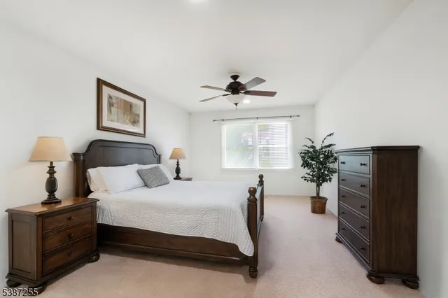 a bedroom with a bed and a potted plant