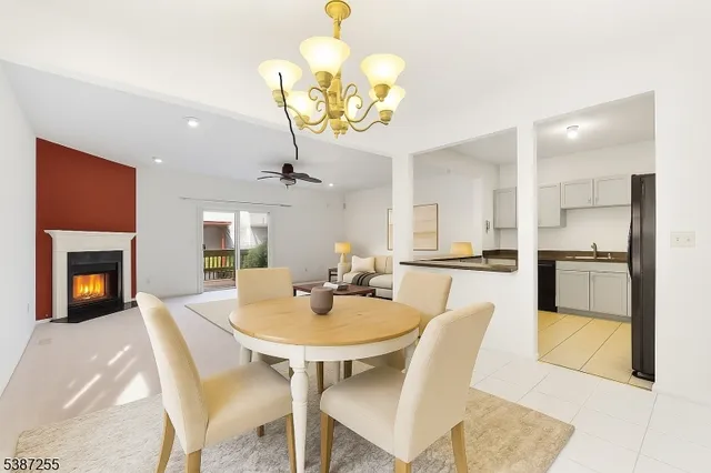 a view of a dining room with furniture and chandelier