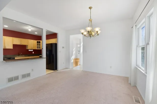 a view of a kitchen with a refrigerator a sink and dishwasher cabinets