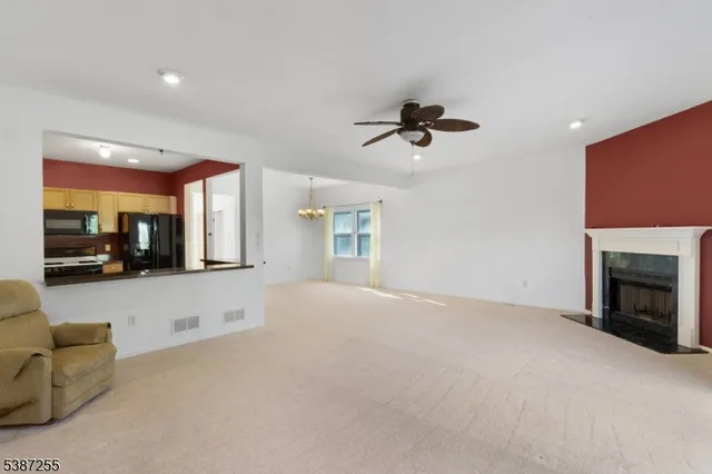 a view of an empty room with a fireplace