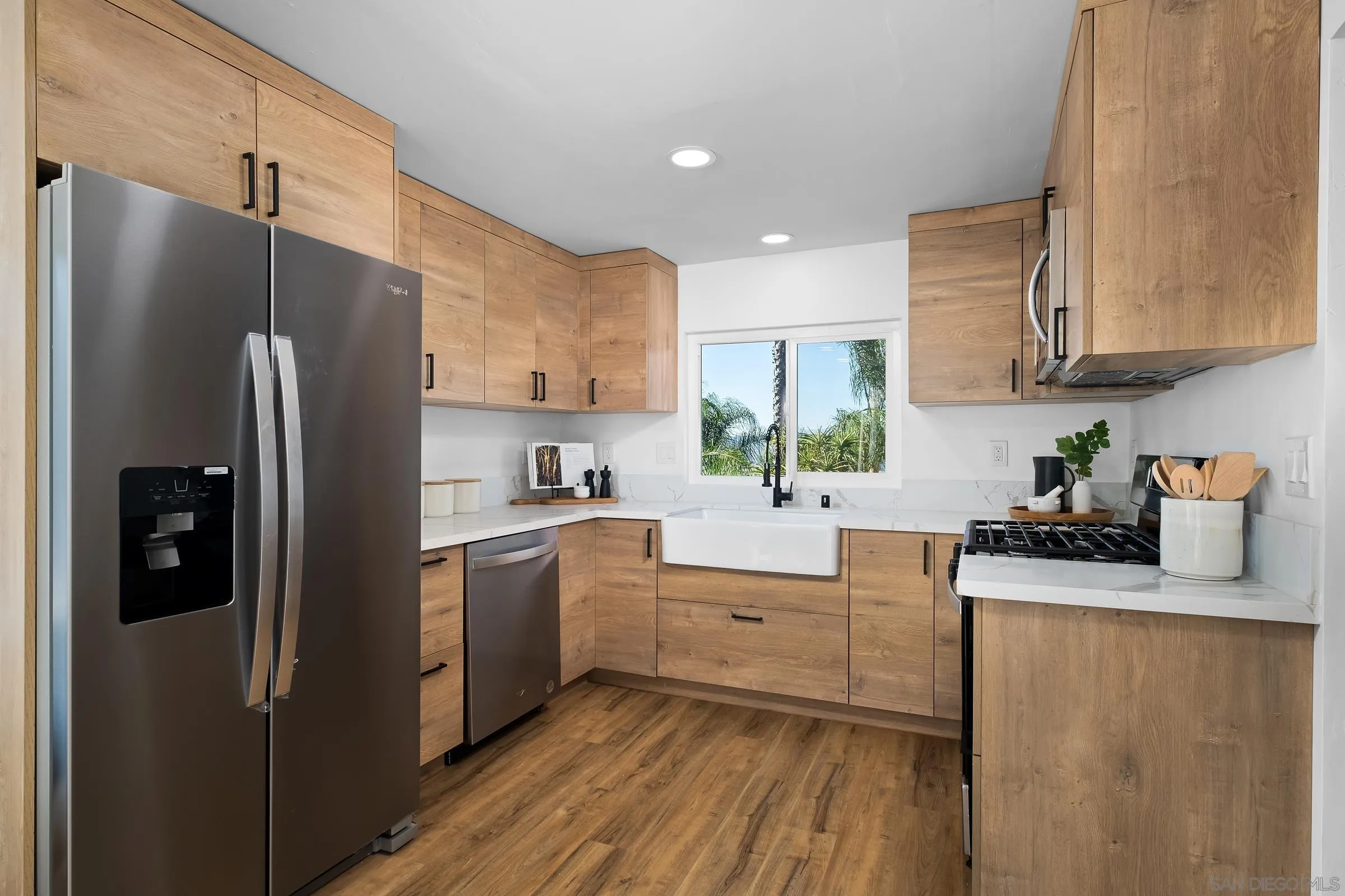 8726 Almond Road Lakeside, CA 92040 - Photo 11 of 31 a kitchen with stainless steel appliances granite countertop a refrigerator sink and cabinets