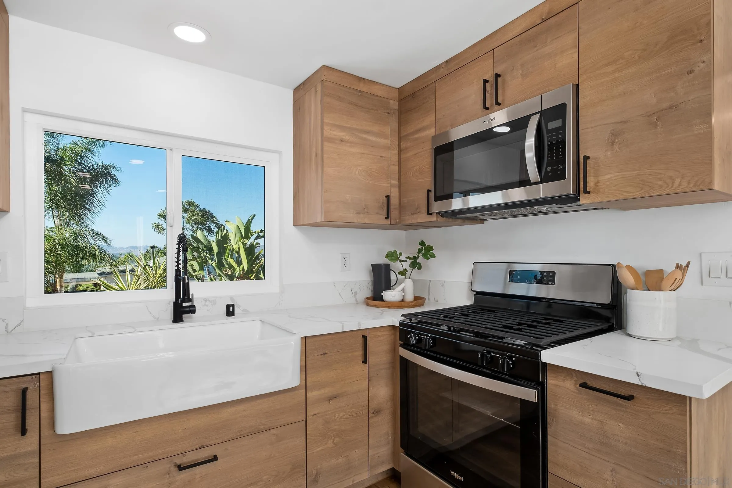 8726 Almond Road Lakeside, CA 92040 - Photo 12 of 31 a kitchen with stainless steel appliances a stove a microwave a sink and cabinets