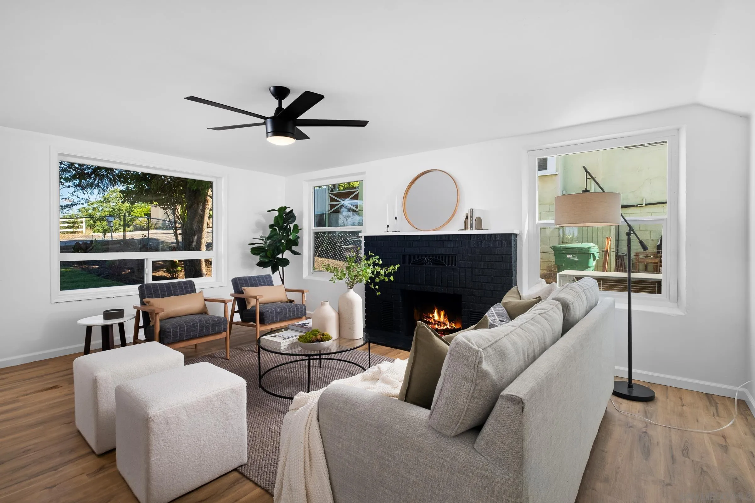 8726 Almond Road Lakeside, CA 92040 - Photo 5 of 31 a living room with furniture a fireplace and a large window