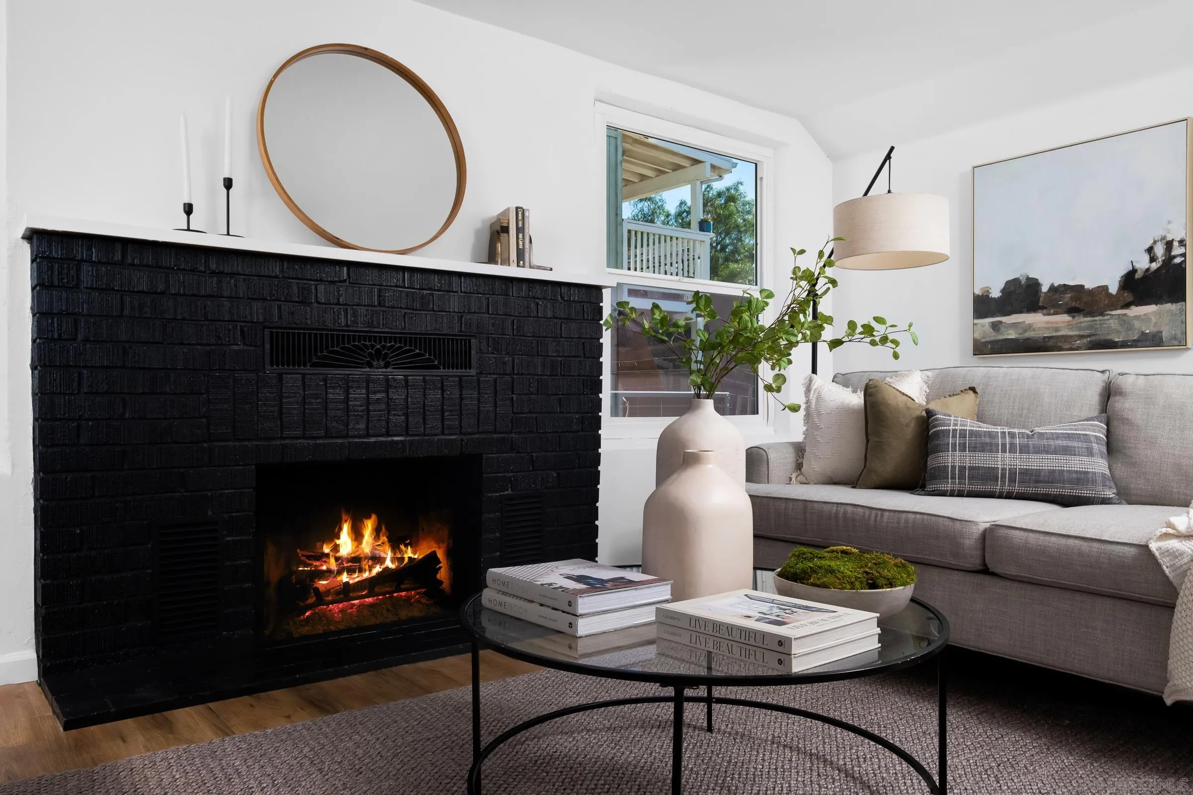 8726 Almond Road Lakeside, CA 92040 - Photo 7 of 31 a living room with furniture a fireplace and a large mirror