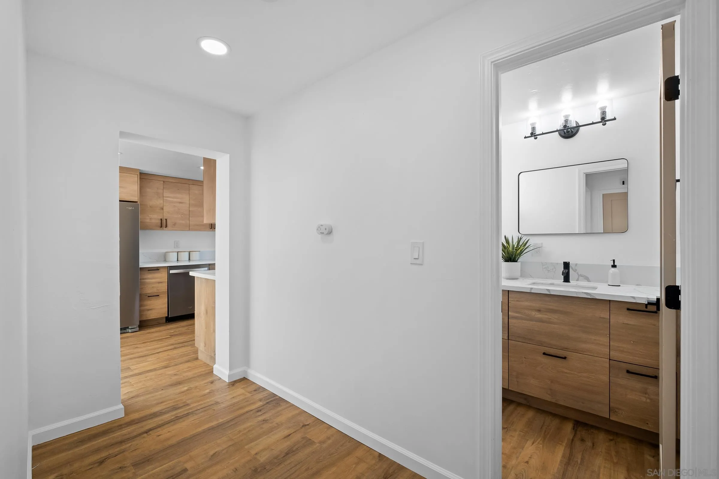 8726 Almond Road Lakeside, CA 92040 - Photo 9 of 31 a bathroom with a vanity a toilet and a mirror