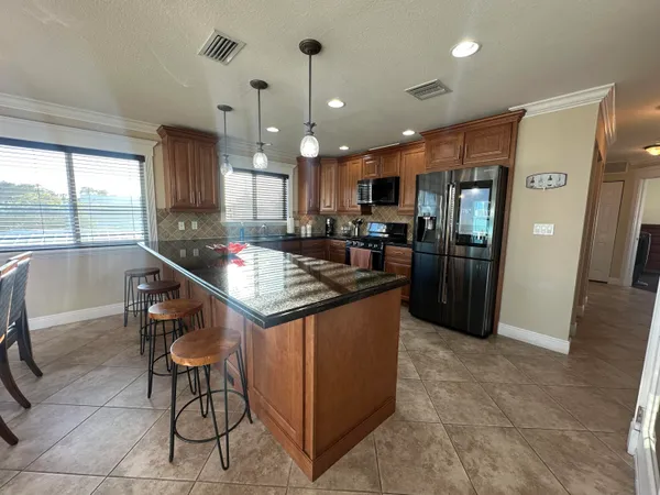 an open kitchen with dining table and chairs