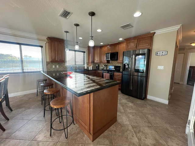 an open kitchen with dining table and chairs