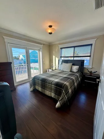 a view of a livingroom with wooden floor and staircase