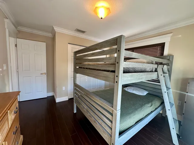 a spacious bedroom with a large bed and a dresser