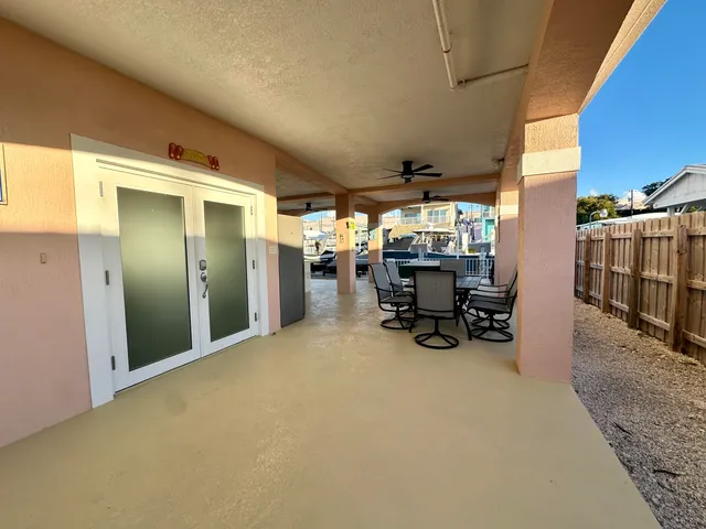 a view of a hallway with potted plants in front of door