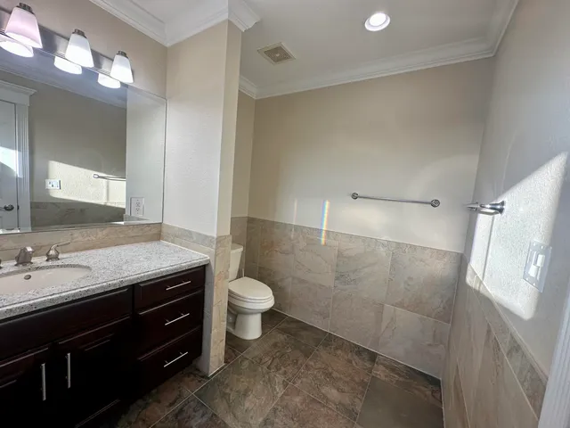 a living room with lots of furniture and kitchen view