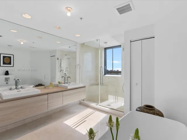 a bathroom with a double vanity sink mirror and double