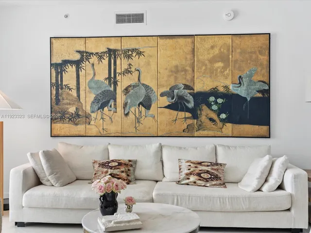 a living room with couch and a large window