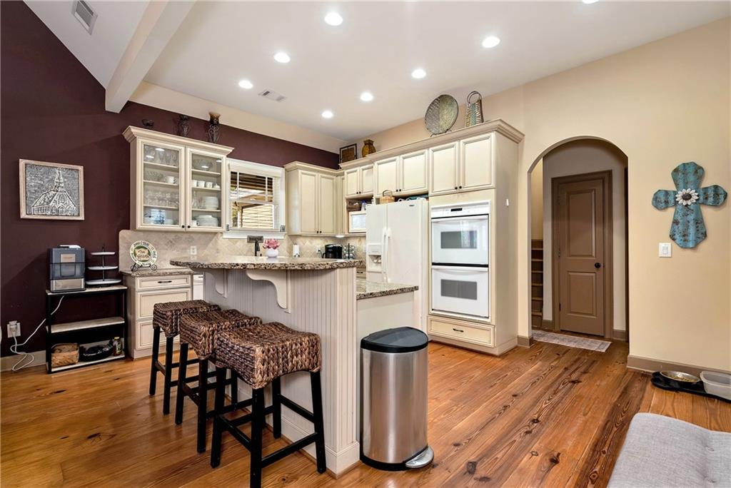 321 Chumbley Road Dawsonville, GA 30534 - Photo 15 of 65 a kitchen with a table chairs refrigerator and cabinets