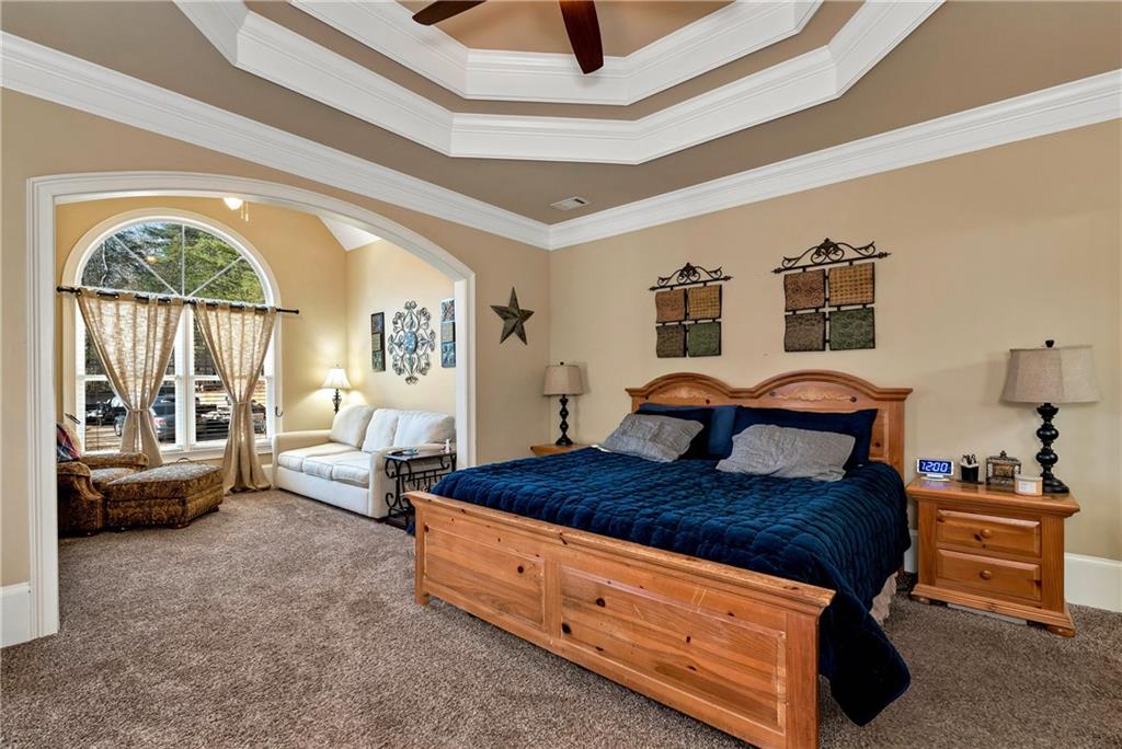 321 Chumbley Road Dawsonville, GA 30534 - Photo 21 of 65 a bedroom with a bed and a large window