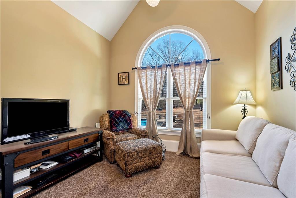 321 Chumbley Road Dawsonville, GA 30534 - Photo 24 of 65 a living room with furniture and a flat screen tv