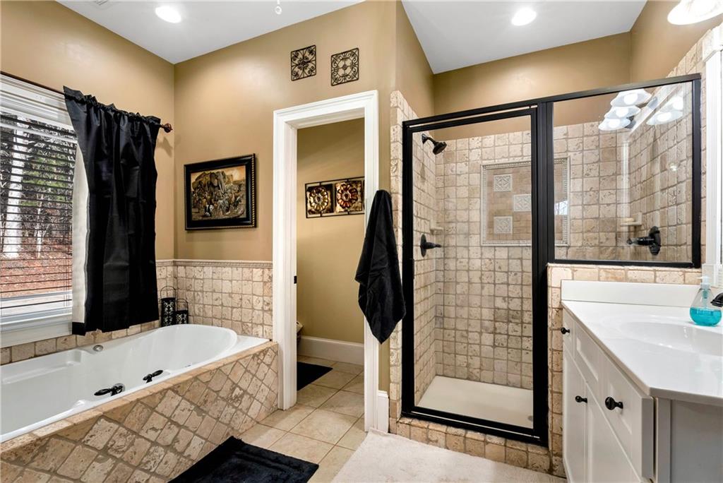 321 Chumbley Road Dawsonville, GA 30534 - Photo 26 of 65 a bathroom with a tub and a shower