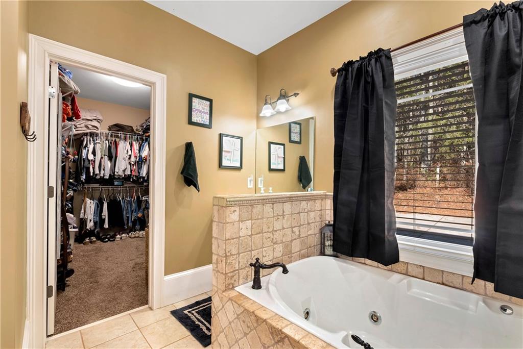 321 Chumbley Road Dawsonville, GA 30534 - Photo 27 of 65 a bathroom with a bathtub and a shower