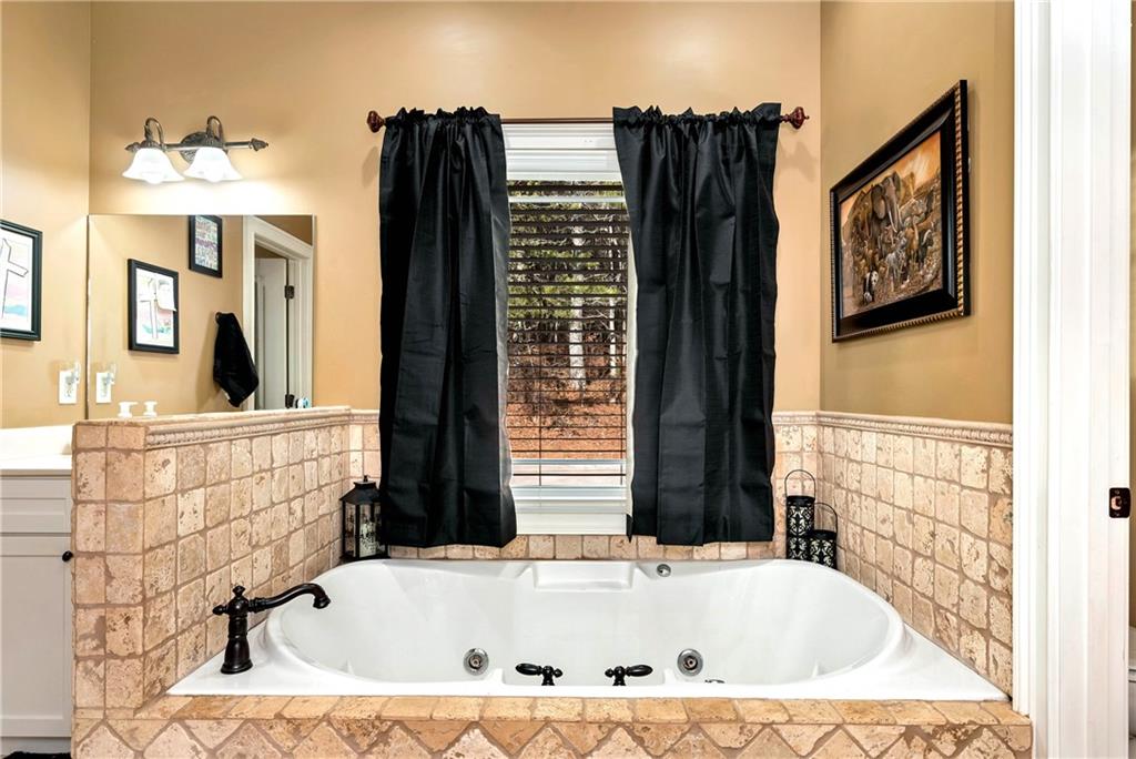 321 Chumbley Road Dawsonville, GA 30534 - Photo 28 of 65 a bathroom with bathtub and shower